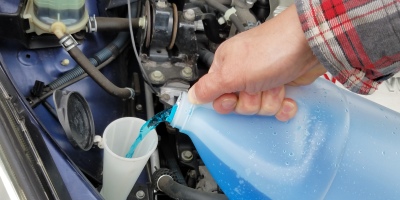 pouring windshield washer fluid