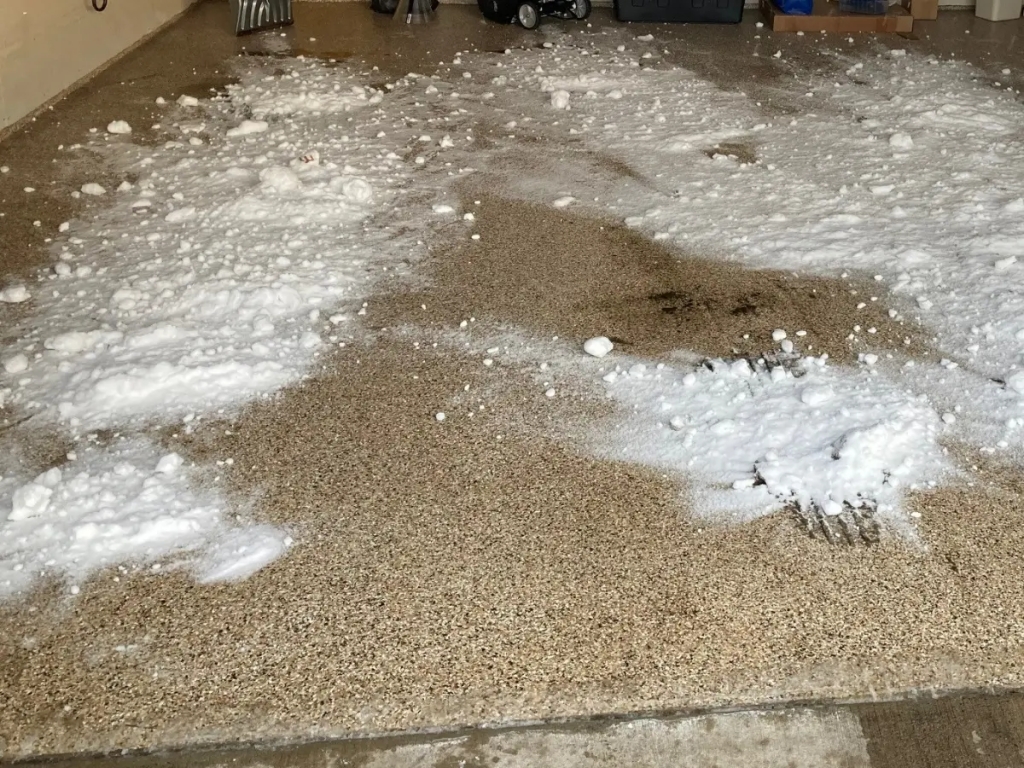 Fresh snow sprinkled on road salt in garage floor